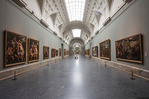 View of an empty gallery at El Prado Museum in Madrid, Spain, Thursday, March 12, 2020. The spread of the new coronavirus continues disrupting normal life in parts of Spain, and it's also affecting sports, cultural and all sorts of leisure events after the government imposed a ban on gatherings of more than 1,000 people and to cut to a third the maximum audience of all venues holding indoor sports or cultural events. Exhibitions, conferences, sports centers and museums are closing in Madrid, including the Spanish capital's Prado Museum for the first time in eight decades. The museum, which hosts works by Francisco de Goya and Diego de Velazquez, among other Spanish and European artists, was forced to shut down last during the Spanish Civil War (1936-39). The vast majority of people recover from the new coronavirus. According to the World Health Organization, most people recover in about two to six weeks, depending on the severity of the illness. (AP Photo/Bernat Armangue)