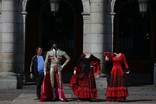 Flamenco and bullfighter costumes are displayed in central Madrid, Spain, Friday, March 13, 2020. Exhibitions, conferences, sports centers and museums are closing in Madrid, including the Spanish capital's Prado Museum for the first time in eight decades. For some, especially older adults and people with existing health problems, it can cause more severe illness, including pneumonia. (AP Photo/Manu Fernandez)