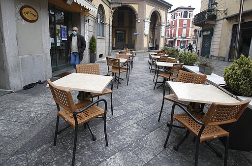 In this photo taken on Thursday, March 12, 2020, a man wearing a mask walks in Codogno, Italy. The northern Italian town that recorded Italy&#146;s first coronavirus infection has offered a virtuous example to fellow Italians, now facing an unprecedented nationwide lockdown, that by staying home, trends can reverse. Infections of the new virus have not stopped in Codogno, which still has registered the most of any of the 10 Lombardy towns Italy&#146;s original red zone, but they have slowed. For most people, the new coronavirus causes only mild or moderate symptoms. For some it can cause more severe illness. (AP Photo/Antonio Calanni)