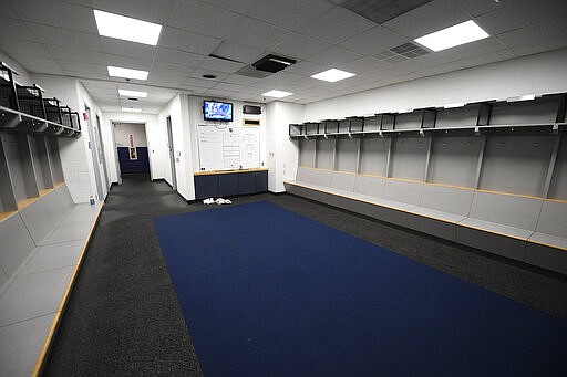 The empty visitors NHL hockey locker room is seen at Capital One Arena in Washington, Thursday, March 12, 2020. The Washington Capitals were to play the Detroit Red Wings later tonight. The NHL is following the NBA&#146;s lead and suspending its season because of the coronavirus pandemic. NHL Commissioner Gary Bettman announced Thursday it is pausing its season, one day after the NBA suspended play after a player tested positive Wednesday for COVID-19.(AP Photo/Nick Wass)