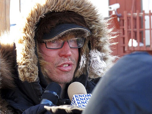 FILE - In this March 12, 2012 file photo, musher Brent Sass speaks to reporters after completing the nearly 1,000 mile Iditarod Trail Sled Dog Race in Nome, Alaska. Sass, coming off back-to-back wins in another long-distance sled dog race, was the first to reach the halfway point of this year's Iditarod Trail Sled Dog Race. The native of Minnesota living near the Alaska community of Eureka arrived late Wednesday night, March 11, 2020 with 13 dogs in harness at the checkpoint in Cripple, where Sass said he planned to take his mandatory 24-hour rest period. (AP Photo/Mark Thiessen, File)