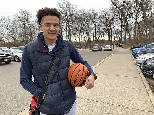 Mack Taylor, 25, poses outside Life Time Fitness in the Minneapolis suburb of Plymouth, Minn., on Saturday, March 14, 2020. Taylor says he still regularly goes to the gym, despite the new coronavirus outbreak. He says his concern is not getting infected himself, but getting infected and passing the virus on to someone else who might have a pre-existing condition. (AP Photo/Jeff Baenen)