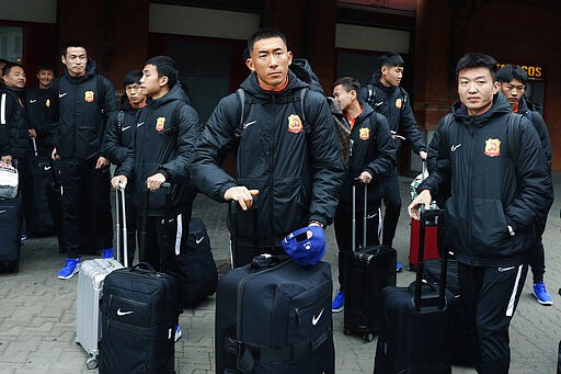 Players of the Chinese Super League team Wuhan Zall arrive at the Atocha train station in Madrid, Spain, Saturday, Feb. 29, 2020. The Chinese first-division soccer club from the city of Wuhan enters its second month in Spain without knowing when it will be able to return home. . It hasn't been easy for the nearly 50 members of the Wuhan Zall squad, but on Sunday they will get some reprieve from their ordeal by attending the Spanish league &quot;clasico&quot; between Real Madrid and Barcelona at the Santiago Bernabeu Stadium in Madrid. (AP Photo/Manu Fernandez)