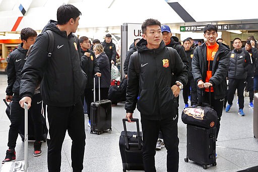 Players of the Chinese Super League team Wuhan Zall arrive at the Atocha train station in Madrid, Spain, Saturday, Feb. 29, 2020. The Chinese first-division soccer club from the city of Wuhan enters its second month in Spain without knowing when it will be able to return home. . It hasn't been easy for the nearly 50 members of the Wuhan Zall squad, but on Sunday they will get some reprieve from their ordeal by attending the Spanish league &quot;clasico&quot; between Real Madrid and Barcelona at the Santiago Bernabeu Stadium in Madrid. (AP Photo/Manu Fernandez)