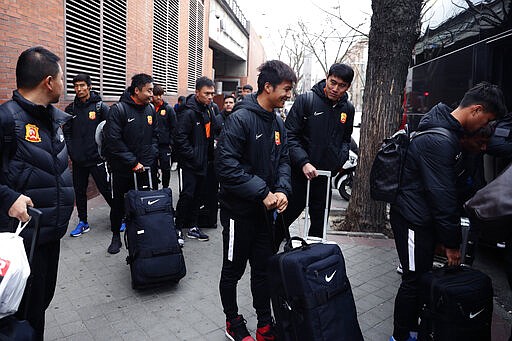 Players of the Chinese Super League team Wuhan Zall arrive at the Atocha train station in Madrid, Spain, Saturday, Feb. 29, 2020. The Chinese first-division soccer club from the city of Wuhan enters its second month in Spain without knowing when it will be able to return home. . It hasn't been easy for the nearly 50 members of the Wuhan Zall squad, but on Sunday they will get some reprieve from their ordeal by attending the Spanish league &quot;clasico&quot; between Real Madrid and Barcelona at the Santiago Bernabeu Stadium in Madrid. (AP Photo/Manu Fernandez)