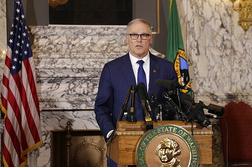 Washington Gov. Jay Inslee talks to the media about the decision to close schools in three counties in response to COVID-19, on Thursday, March 12, 2020, in Olympia, Wash. All public and private K-12 schools in King, Pierce and Snohomish counties will be closed for six weeks, and Inslee said there could be closures in more counties soon. (AP Photo/Rachel La Corte)