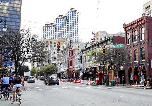 FILE - This March 12, 2016 file photo shows a general view of Sixth Street during South By Southwest in Austin, Texas. Austin city officials have canceled the South by Southwest arts and technology festival. Mayor Steve Adler announced a local disaster as a precaution because of the threat of the novel coronavirus, effectively cancelling the annual event that had been scheduled for March 13-22.  (Photo by Rich Fury/Invision/AP, File)