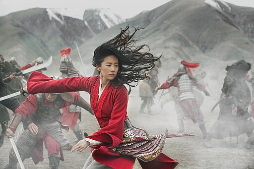 This image released by Disney shows Yifei Liu in the title role of &quot;Mulan.&quot; The Walt Disney Co. officially postponed the theatrical release of &#147;Mulan,&quot; amid the coronavirus outbreak. It was was set to come out at the end of the month. For most people, the new coronavirus causes only mild or moderate symptoms. For some it can cause more severe illness. (Jasin Boland/Disney via AP)