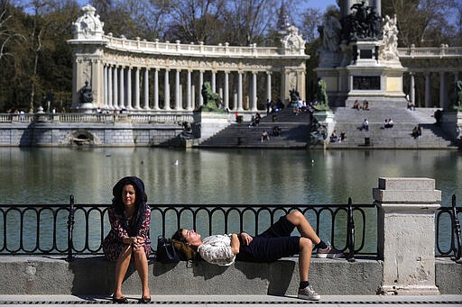 People enjoy the sun at the Retiro Park in Madrid, Spain, Saturday, March 14, 2020. Spanish Prime Minister Pedro Sanchez said his government will declare a two-week state of emergency from Saturday, giving itself extraordinary powers including the mobilization of the armed forces, to confront the COVID-19 outbreak. For some, especially older adults and people with existing health problems, it can cause more severe illness, including pneumonia. (AP Photo/Manu Fernandez)