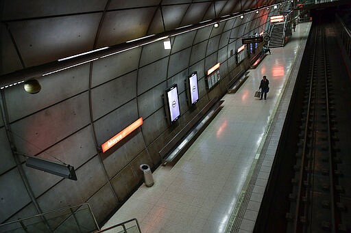 Passengers wait in an empty subway station, in Bilbao, northern Spain, Saturday, March 14, 2020. Spain's prime minister has announced a two-week state of emergency from Saturday in a bid to contain the new coronavirus outbreak. For most people, the new COVID-19 coronavirus causes only mild or moderate symptoms, such as fever and cough, but for some, especially older adults and people with existing health problems, it can cause more severe illness, including pneumonia. (AP Photo/Alvaro Barrientos)