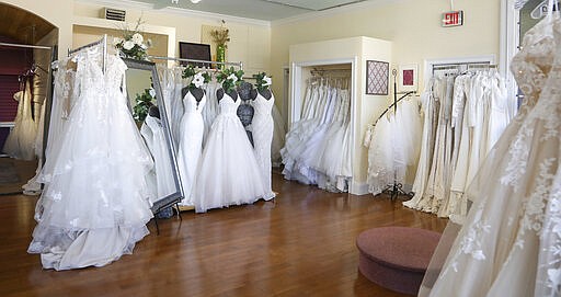 Wedding dresses are displayed at Complete Bridal, a shop in East Dundee, Illinois, on February 28, 2020. The store is heavily reliant on China for manufacturing. Factory closures there have meant fewer choices for brides.  Those with weddings coming up soon have to buy off the rack and forego customization. (AP Photo/Teresa Crawford)