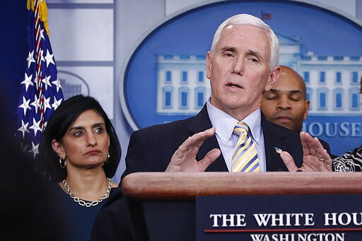 Vice President Mike Pence speaks during a briefing on coronavirus in the Brady press briefing room at the White House, Saturday, March 14, 2020, in Washington, as Administrator of the Centers for Medicare and Medicaid Services Seema Verma, left, listens. (AP Photo/Alex Brandon)