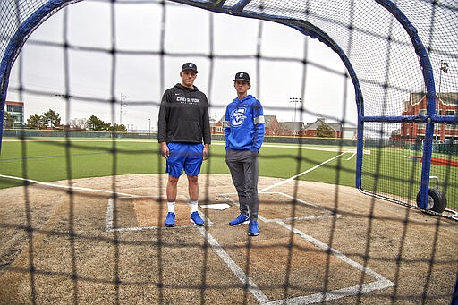 In this March 13, 2020 photo, Creighton NCAA college baseball pitchers Ben Dotzler and Tommy Steier, right, pose for a photo at home plate in Omaha, Neb. Dotzler was supposed to be in the bullpen at TD Ameritrade Park this weekend readying himself to pitch against Northern Colorado, Everything changed for hm and thousands of other college athletes when the NCAA announced March 12, 2020, it was canceling all spring sports championships, along with remaining winter championships, as a precaution against the spread of the new coronavirus.   (AP Photo/Nati Harnik)