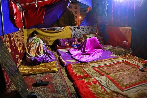 In this Friday, March 6, 2020 photo, protesters rest in their sit-in tent, in Baghdad, Iraq. The youthful protesters are struggling to keep their movement going after one set-back after another, now capped by fears over the coronavirus outbreak. Where once Baghdad&#146;s Tahrir Square had seen thousands every day, now only a few hundred protesters turn up. For most people, the virus causes only mild or moderate symptoms. For some it can cause more severe illness. (AP Photo/Hadi Mizban)