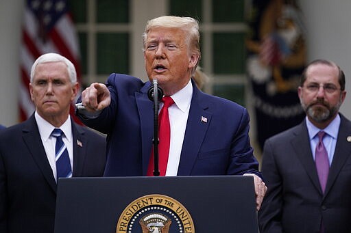 President Donald Trump takes questions during a news conference about the coronavirus in the Rose Garden of the White House, Friday, March 13, 2020, in Washington. Vice President Mike Pence, left, and Department of Health and Human Services Secretary Alex Azar, right listen. (AP Photo/Evan Vucci)