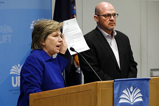 CORRECTS THAT WEINGARTEN IS PRESIDENT OF TEACHERS NOT UNITED FEDERATION OF TEACHERS - American Federation of Teachers President Randi Weingarten, and Michael Mulgrew, president of the United Federation of Teachers in New York City, address a news conference at UFT headquarters, in New York, Sunday, March 15, 2020. The New York City Council announced Sunday that it is suspending all hearings and meetings, but Mayor Bill de Blasio said he's still reluctant to shut down schools as other major U.S. cities have despite pressure from teachers to do so. (AP Photo/Richard Drew)