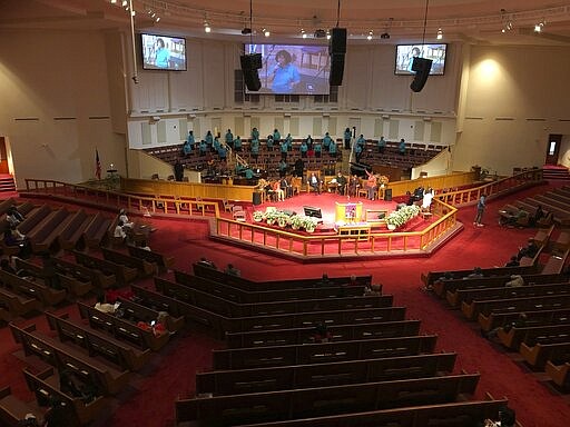 The choir sings during services on at St. Philip African Methodist Episcopal Church in Atlanta on Sunday, March 15, 2020. Only about 100 people filled a sprawling sanctuary that seats more than a thousand at the church because of coronavirus fears. Pastor William Watley told congregants he would follow officials' guidance on whether to continue services after Sunday, calling for prayer during the epidemic. (Jeff Amy/Associated Press)