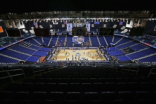 Greensboro Coliseum is mostly empty after the NCAA college basketball games were cancelled at the Atlantic Coast Conference tournament in Greensboro, N.C., Thursday, March 12, 2020. The biggest conferences in college sports all canceled their basketball tournaments because of the new coronavirus, seemingly putting the NCAA Tournament in doubt. (AP Photo/Gerry Broome)