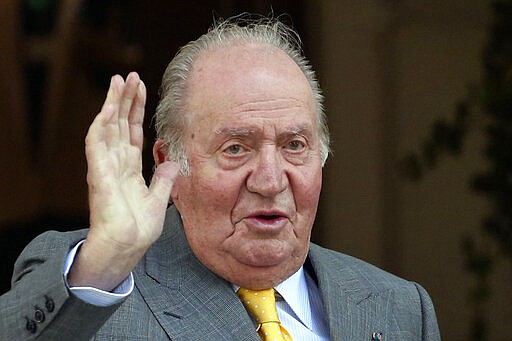 FILE - In this March 10, 2018 file photo, Spain's former monarch King Juan Carlos waves upon his arrival to the Academia Diplomatica de Chile, in Santiago. The Spanish parliament's decision-making board has rejected two proposals calling for the lower chamber to investigate whether former King Juan Carlos received millions of dollars in kick-back payments from Saudi Arabia. The proposals voted Tuesday March 10, 2020 were triggered by an ongoing investigation by Swiss prosecutors into an account reportedly operated for the Spanish monarch, including an alleged payment of 88 million euros (100 million dollars) by late Saudi King Abdullah in 2008. (AP Photo/Esteban Felix, File)