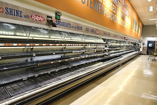 An entire section of meat and poultry is left empty after panicked shoppers swept through in fear of the coronavirus at a local grocery store in Burbank, Calif. on Saturday, March 14, 2020. Californians wanting to escape the new reality of the coronavirus at the movies, casino or amusement park are running into the six foot rule. State health officials issued new guidance Saturday urging theaters to keep attendance under 250 people and ask strangers to sit six feet apart. (AP Photo/Richard Vogel)