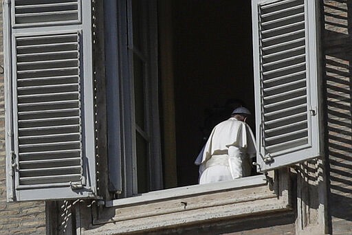 Pope Francis leaves after delivering his blessing from his studio window overlooking St. Peter's Square at the Vatican, Sunday March 15, 2020. For most people, the new coronavirus causes only mild or moderate symptoms. For some, it can cause more severe illness, especially in older adults and people with existing health problems. (AP Photo/Alessandra Tarantino)