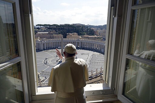 Pope Francis delivers his blessing from inside the Apostolic library at the Vatican, Sunday, March 15, 2020. Pope Francis has praised people who could risk contagion to help the poor and the homeless even as fears of coronavirus spread prompts ever more countries to restrict ways of everyday life. For most people, the new coronavirus causes only mild or moderate symptoms. For some, it can cause more severe illness, especially in older adults and people with existing health problems. (Vatican News via AP)