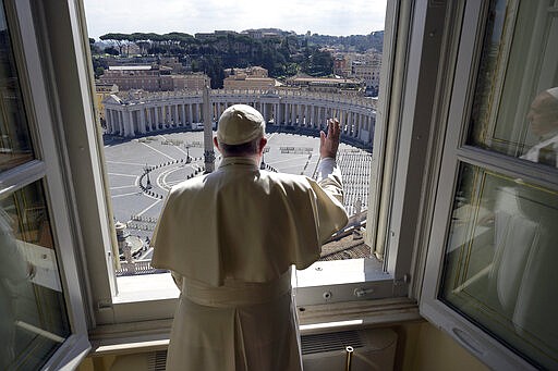 Pope Francis delivers his blessing from inside the Apostolic library at the Vatican, Sunday, March 15, 2020. Pope Francis has praised people who could risk contagion to help the poor and the homeless even as fears of coronavirus spread prompts ever more countries to restrict ways of everyday life. For most people, the new coronavirus causes only mild or moderate symptoms. For some, it can cause more severe illness, especially in older adults and people with existing health problems. (Vatican News via AP)