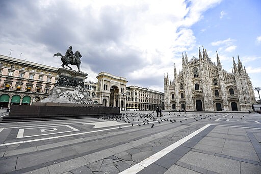 Pigeons took posses of Duomo square in Milan, Italy, Sunday, March 15, 2020, as most people remained home following the indications of doctors and the government in order to slow down the spread of the new coronavirus. For most people, the new coronavirus causes only mild or moderate symptoms. For some, it can cause more severe illness, especially in older adults and people with existing health problems. (Claudio Furlan/LaPresse via AP)