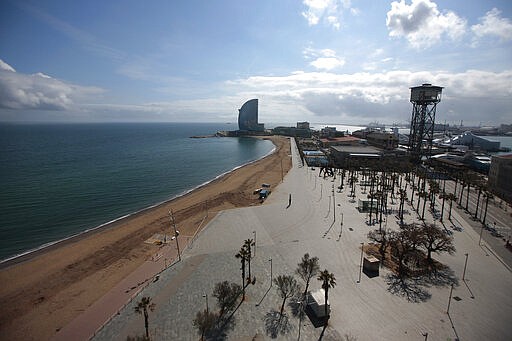 An empty beach in Barcelona, Spain, Sunday, March 15, 2020. Spain awoke to its first day of a nationwide quarantine on Sunday after the government declared a two-week state of emergency and put in place extraordinary measures including the confinement of people to their homes unless shopping for food and medicine, going to and from work, and to meet other basic needs. Restaurants and hotels are closed and public transport reduced. For most people, the new coronavirus causes only mild or moderate symptoms. For some, it can cause more severe illness, especially in older adults and people with existing health problems. (AP Photo/Joan Mateu)