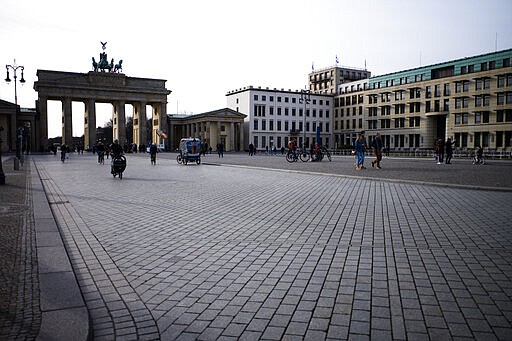 The Pariser Platz in front of the Brandenburg Gate is almost empty in Berlin, Germany, Sunday, March 15, 2020. Berlin has closed all bars and pubs because of the coronavirus outbreak. For most people, the new coronavirus causes only mild or moderate symptoms, such as fever and cough. For some, especially older adults and people with existing health problems, it can cause more severe illness, including pneumonia.(AP Photo/Markus Schreiber)