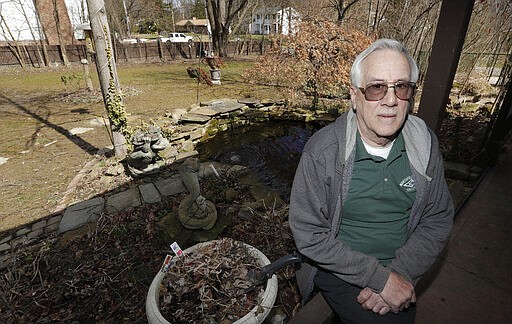 In this Friday, March 13, 2020 photo, Paul Buescher poses on his back porch, in Northfield Center Township, Ohio. Buescher is one of 32 members of a group in northeastern Ohio that shares a farm packed with enough canned and dehydrated food and water to last for years. For those in the often-mocked &quot;prepper&quot; community, this is quickly becoming their &quot;I told you so&quot; moment, as panic buying has cleared store shelves across the U.S. amid growing fears that the new coronavirus will force many Americans to self-quarantine for weeks in their homes.  (AP Photo/Tony Dejak)