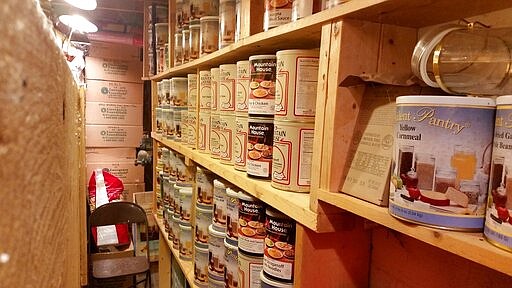 In this undated photo provided by Paul Buescher, canned food rests on shelves in a barn near Garretsville, Ohio. The food can be used by 32 members of a group in northeastern Ohio that shares a farm packed with enough canned and dehydrated food and water to last for years. For those in the often-mocked &quot;prepper&quot; community, this is quickly becoming their &quot;I told you so&quot; moment, as panic buying has cleared store shelves across the U.S. amid growing fears that the new coronavirus will force many Americans to self-quarantine for weeks in their homes. (Paul Buescher via AP)