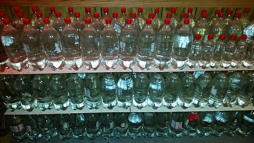 In this undated photo provided by Paul Buescher, water is stored in stacks of 2-liter bottles in a barn near Garrettsville, Ohio. The water can be used by 32 members of a group in northeastern Ohio that shares a farm packed with enough canned and dehydrated food and water to last for years. For those in the often-mocked &quot;prepper&quot; community, this is quickly becoming their &quot;I told you so&quot; moment, as panic buying has cleared store shelves across the U.S. amid growing fears that the new coronavirus will force many Americans to self-quarantine for weeks in their homes. (Paul Buescher via AP)