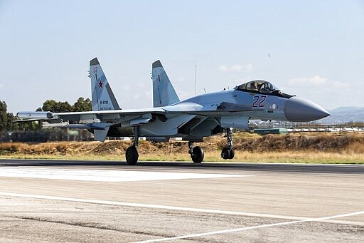 FILE - This Sept. 26, 2019 file photo, shows a Russian Su-35 fighter jet taking off at Hemeimeem air base in Syria. In a world gripped by a pandemic, global unrest and a fast-moving news cycle, it can be difficult to remember that the war in Syria is still happening. (AP Photo/Alexander Zemlianichenko, File)