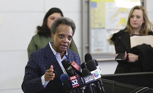 Chicago Mayor Lori Lightfoot speaks to reporters Sunday, March 15, 2020, at O'Hare International Airport. 
Harsh criticism rained on the Trump administration from state and local officials over long lines of returning international passengers at some U.S. airports that could have turned them into coronavirus carriers as they tried to get home. Mayor Lightfoot lambasted the administration for allowing about 3,000 Americans returning from Europe to be stuck for hours inside the customs area at O'Hare International Airport on Saturday, violating federal recommendations that people practice &#147;social distance.&quot; (AP Photo/Teresa Crawford)