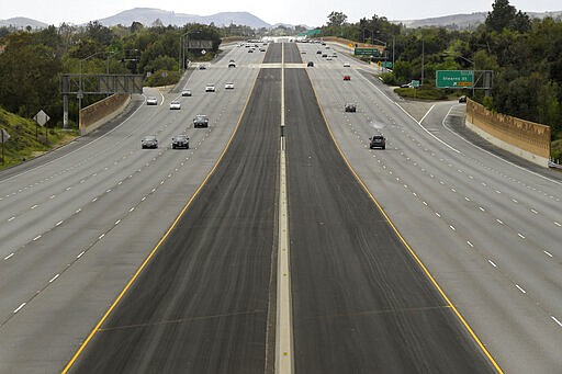 CORRECTS LOCATION TO SIMI VALLEY, INSTEAD OF SIM VALLEY - Light traffic is seen in the afternoon on the 118 Ronald Reagan freeway, Sunday, March 15, 2020, in Simi Valley, Calif. The highway is usually much busier on a Sunday afternoon. (AP Photo/Mark J. Terrill)