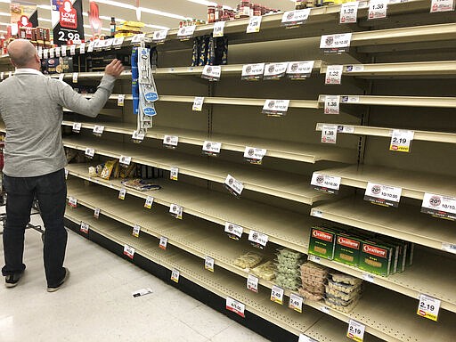 This photo shows empty shelves at a Hy-Vee supermarket in Omaha, Neb., Sunday, March 15, 2020. Shoppers have been buying up extra quantities of products since the outbreak of the coronavirus. (AP Photo/Nati Harnik)