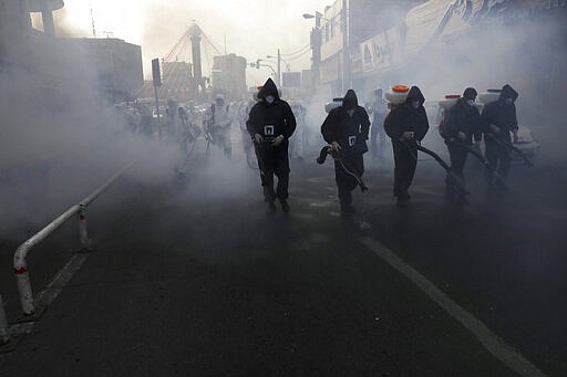 Firefighters disinfect a street against the new coronavirus, in western Tehran, Iran, Friday, March 13, 2020. The new coronavirus outbreak has reached Iran's top officials, with its senior vice president, Cabinet ministers, members of parliament, Revolutionary Guard members and Health Ministry officials among those infected.  The vast majority of people recover from the new coronavirus. According to the World Health Organization, most people recover in about two to six weeks, depending on the severity of the illness. (AP Photo/Vahid Salemi)