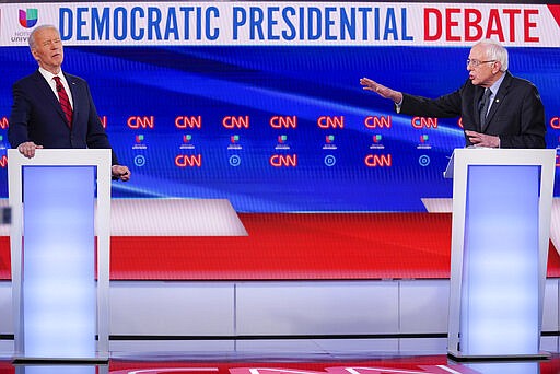 Former Vice President Joe Biden, left, and Sen. Bernie Sanders, I-Vt., right, participate in a Democratic presidential primary debate at CNN Studios in Washington, Sunday, March 15, 2020. (AP Photo/Evan Vucci)