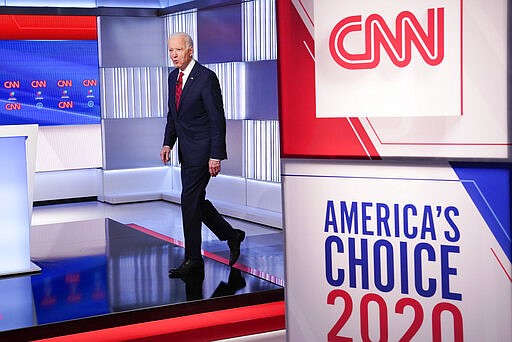 Former Vice President Joe Biden walks on stage as he is introduced at the Democratic presidential primary debate at CNN Studios in Washington, Sunday, March 15, 2020. (AP Photo/Evan Vucci)