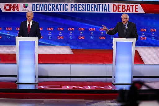 Former Vice President Joe Biden, left, and Sen. Bernie Sanders, I-Vt., right, participate in a Democratic presidential primary debate at CNN Studios in Washington, Sunday, March 15, 2020. (AP Photo/Evan Vucci)