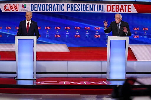 Former Vice President Joe Biden, left, and Sen. Bernie Sanders, I-Vt., right, participate in a Democratic presidential primary debate at CNN Studios in Washington, Sunday, March 15, 2020. (AP Photo/Evan Vucci)