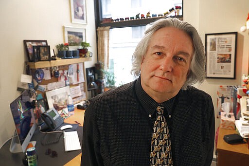 In this Monday, March 9, 2020, photo, David Kidwell, special projects editor with the Better Government Association, poses for a portrait at his office office in Chicago. Political misinformation is often considered a national and international challenge, in part because of the Russian-based trolls and bots who spread false claims and sowed division in a bid to influence the 2016 U.S. election. It's increasingly a problem on Main Street, too, as local candidates and politicians adopt misinformation tactics and local news organizations shrink or shut down, leaving residents with fewer credible sources of information. (AP Photo/Charles Rex Arbogast)