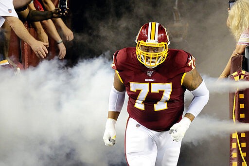 FILE - In this Sept. 23, 2019, file photo, Washington Redskins offensive tackle Ereck Flowers runs onto the field prior to during an NFL football game against the Chicago Bears in Landover, Md. Offensive lineman Ereck Flowers has agreed to terms on a $30 million, three-year contract with the Miami Dolphins, Monday, March 16, 2020 .(AP Photo/Mark Tenally, File)