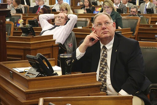 Kansas House Majority Leader Dan Hawkins, R-Wichita, watches an electronic vote-tallying board as the chamber approves a plan for improving the state's highway system, Monday, March 16, 2020, at the Statehouse in Topeka, Kan. Top Republicans in the GOP-controlled Legislature want to approve a transportation bill before lawmakers take an early and long spring break because of the coronavirus pandemic. (AP Photo/John Hanna)