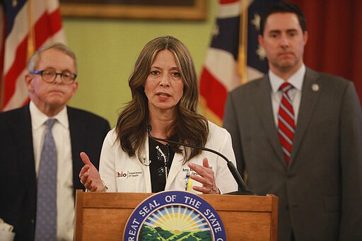 Ohio Department of Health director Dr. Amy Acton speaks at a news conference about the coronavirus Saturday, March 14, 2020 at the Ohio Statehouse. Behind her is Ohio Gov. Mike DeWine (left) and Secretary of State Frank LaRose. (Doral Chenoweth/The Columbus Dispatch via AP)