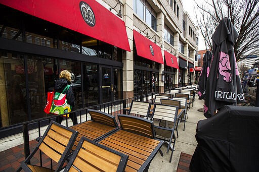 A downtown Bethesda, Md. restaurant is closed as Maryland Gov. Larry Hogan's executive order takes effect, closing bars, restaurants, gyms and movie theaters across the state in response to coronavirus, Monday, March 16, 2020. Hogan's executive order took effect Monday at 5 p.m. Drive-thru, carryout and delivery service will still be allowed. (AP Photo/Manuel Balce Ceneta)