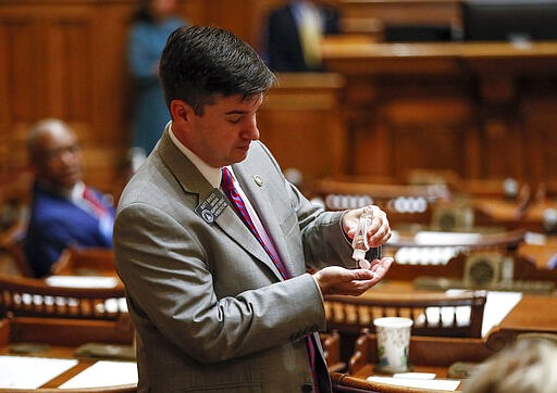 Sen. Matt Brass, R - Newnan, applies hand sanitizer before a special session on Monday, March 16, 2020 in Atlanta. Georgia's lawmakers are granting Gov. Brian Kemp broad powers to combat the spread of the new coronavirus in the state.   They set April 13, the Monday after Easter, as the end date for Kemp's powers.     The vast majority of people recover from the new coronavirus. According to the World  Health Organization, most people recover in about two to six weeks, depending on the severity of the illness.  (Bob Andres/Atlanta Journal-Constitution via AP)