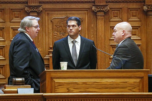 Minority leader Steve Henson, left, D - Stone Mountain, Lt. Gov. Geoff Duncan, center, and Majority leader Mike Dugan, R - Carrollton, confer before the vote to grant Gov. Brian Kemp broad powers to combat the spread of the new coronavirus in Georgia, Monday, March 16, 2020, in Atlanta. (Bob Andres/Atlanta Journal-Constitution via AP)