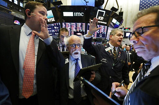 New York Stock Exchange Floor Governor Brendan Connolly, left, works with traders Peter Tuchman, John Panin and Sal Suarino, second left to right, on the floor of the NYSE, March 9, 2020. (AP Photo/Richard Drew)